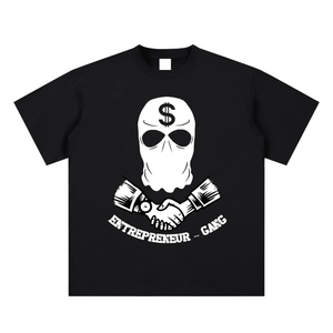 Black t-shirt with a white graphic design featuring a mask with a dollar sign, sunglasses, and crossed axes with text on a white background.