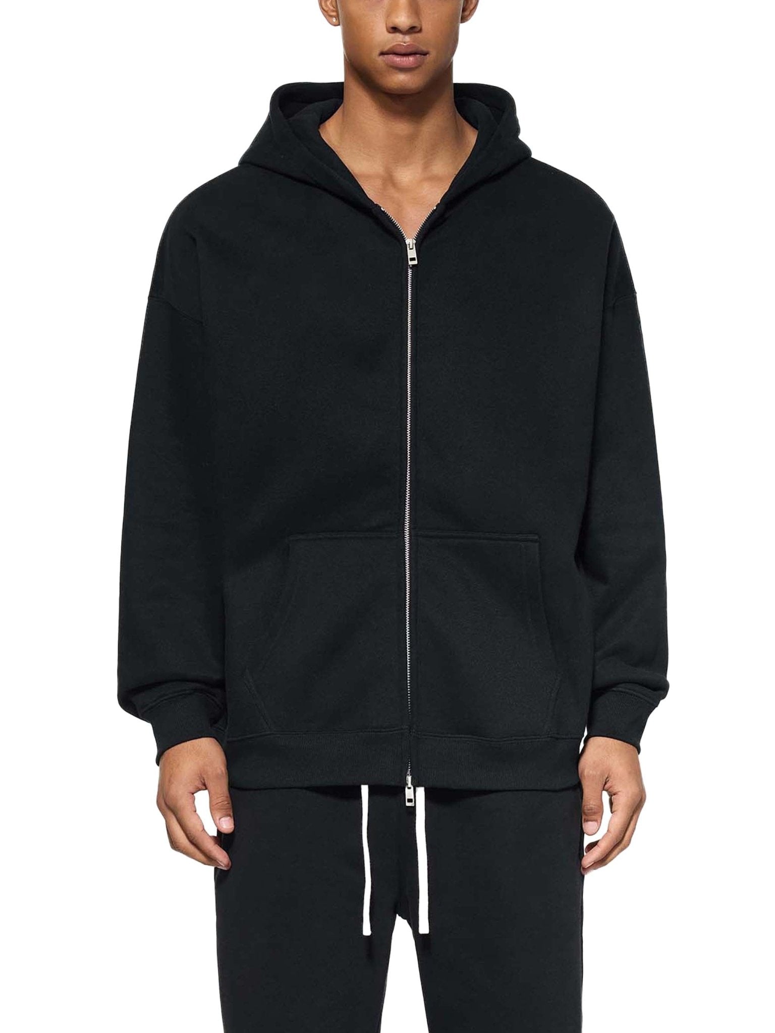 Person wearing a black hoodie with a white background