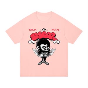 A light pink short-sleeve t-shirt with a graphic print of a cartoon character with a red afro and the words 'SICK MAN' on the front, displayed on a solid white background.