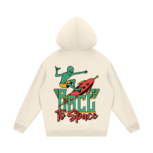 Beige hoodie with a graphic of a green alien on a rocket and 'Race to Space' text on a white background