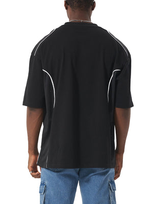 Person wearing a black t-shirt with white accents on a white background