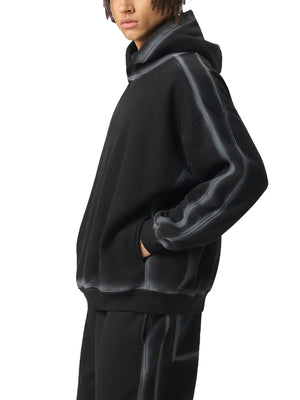 Person wearing a black hoodie and pants on a white background