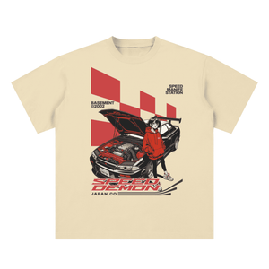 Beige t-shirt with a graphic of a person in a red hoodie working on a car, titled 'Speed Demon Japan'.