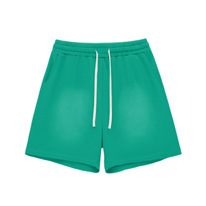Green shorts with a white drawstring on a white background