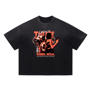 A black short-sleeve t-shirt with a distressed, washed texture and small tear details on the sleeves and hem. The front features a large graphic print with the words 'LOVE IS THUG' and 'REBEL SOUL' in red and orange, accompanied by an illustration of a woman, a dog, and a wolf.