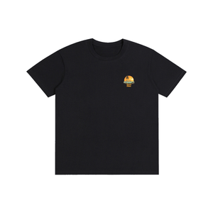 A black short-sleeve crewneck t-shirt with a small circular graphic on the left chest, displayed flat against a solid white background.