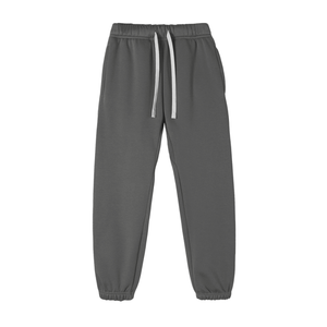 Black pants with decorative buttons on a white background