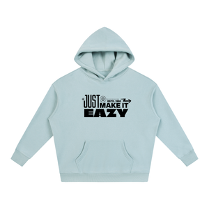 A light blue pullover hoodie with a black graphic text print reading 'JUST MAKE IT EASY' on the chest, displayed against a solid white background.
