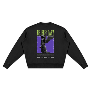 A black crewneck sweatshirt shown from the back, featuring a graphic print of a winged statue on a purple background with the text 'BE LEGENDARY' in lime green and additional small text below.