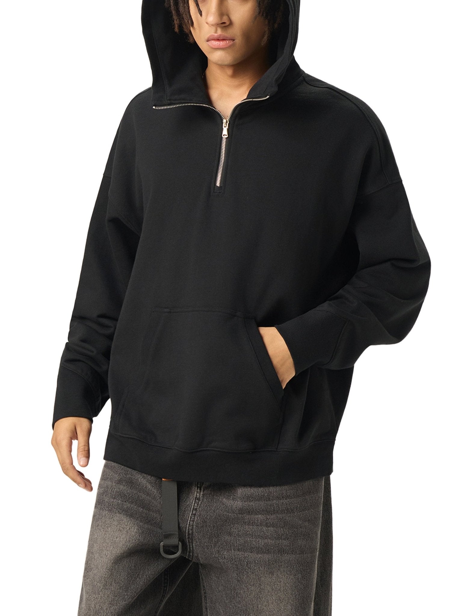 Person wearing a black hoodie with a zipper on a white background