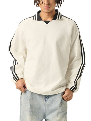 Person wearing a white sweatshirt with black stripes on a white background