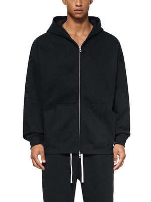 Person wearing a black hoodie with a white background
