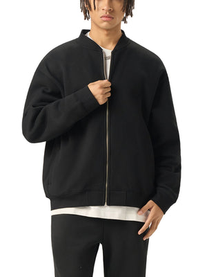 Person wearing a black bomber jacket on a white background