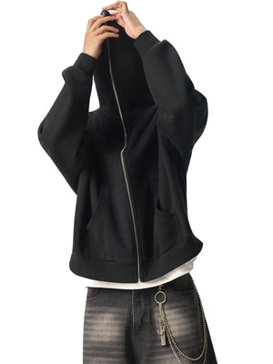 Person wearing a black jacket with a white shirt and jeans on a white background