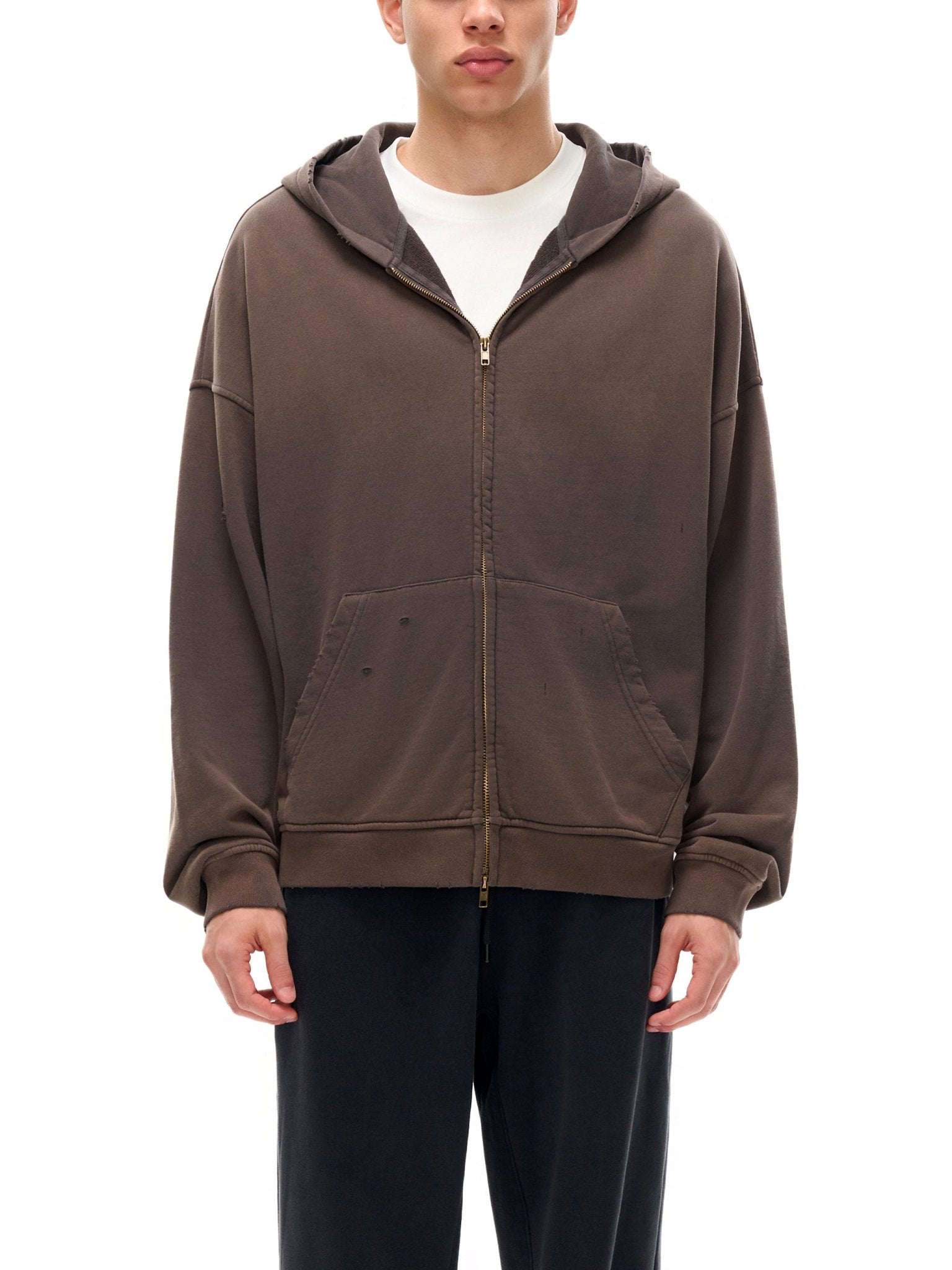 Person wearing a brown hoodie on a white background