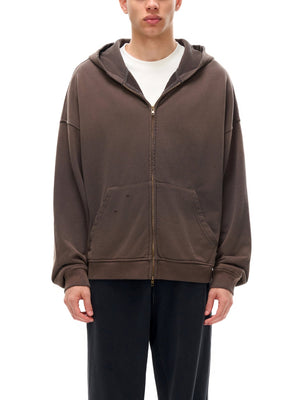 Person wearing a brown hoodie on a white background