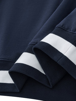Close-up of navy blue sweatshirt with white stripes on cuffs and hem