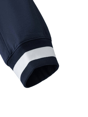 Close-up of navy blue sweatshirt with white trim on a white background