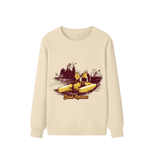 Beige long-sleeve shirt with a graphic of two people in kayaks and 'Just Relax' text on a white background