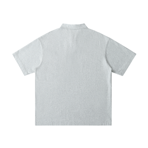 Back view of a light gray polo shirt on a white background