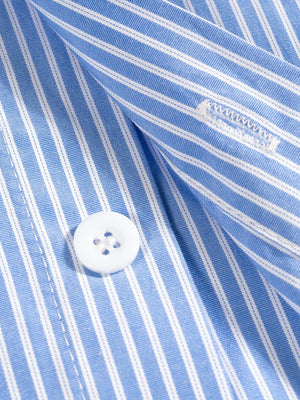Close-up of a blue and white striped shirt with a button, showing a brand label.
