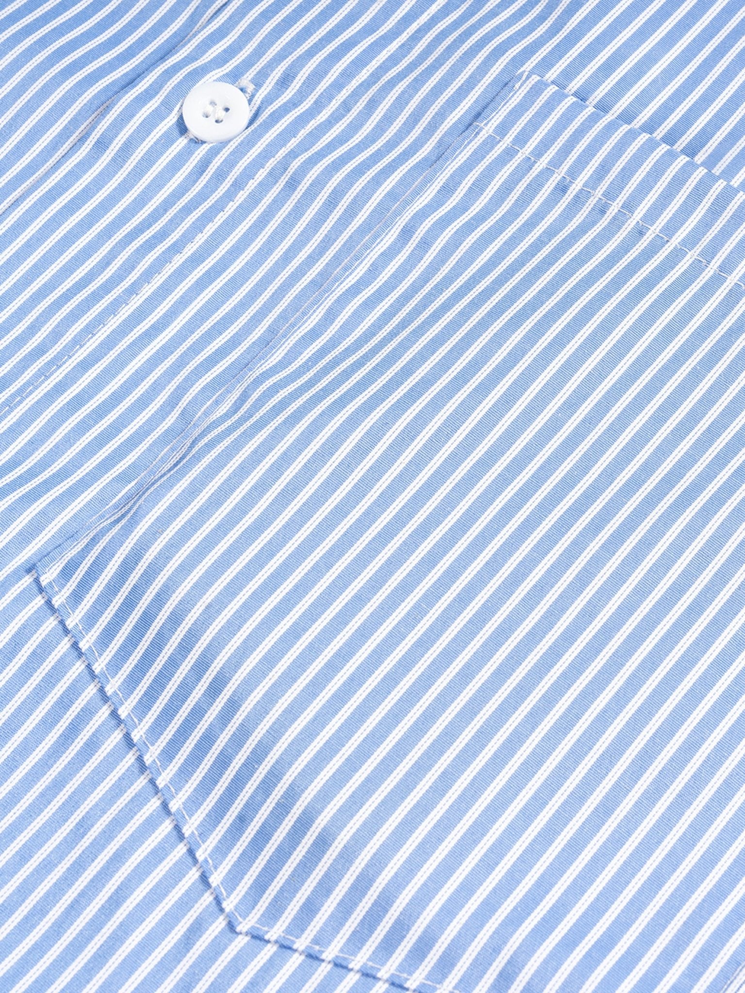 Close-up of a blue and white striped fabric with a button.