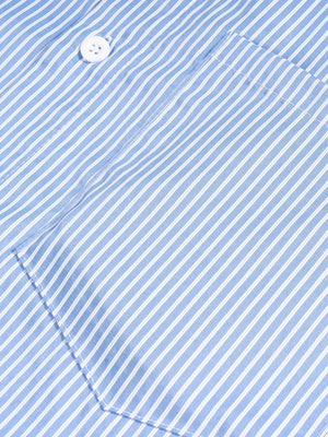 Close-up of a blue and white striped fabric with a button.