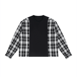 A long-sleeve crop top featuring a solid black center panel and black-and-white plaid patterned sleeves, laid flat on a white background.