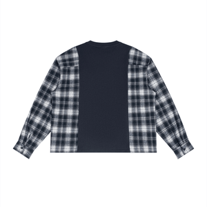 A long-sleeve button-up shirt with a navy blue solid center panel and black-and-white plaid sleeves, shown flat against a white background.