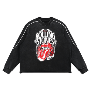 A black acid-wash long-sleeve sweatshirt featuring the iconic red and white Rolling Stones tongue and lips graphic on the front, with white piping along the shoulders and sleeves.