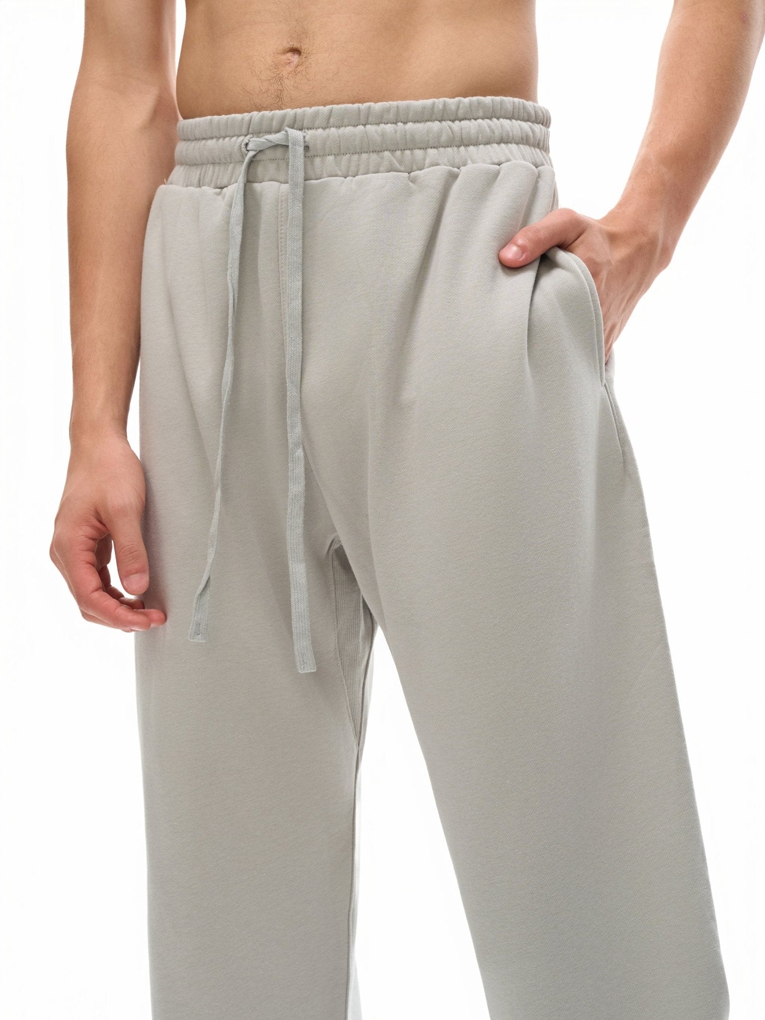 Light gray sweatpants with a drawstring on a white background