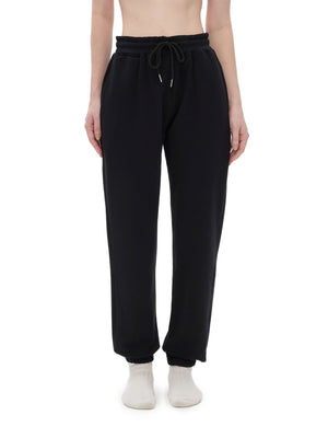 Black sweatpants worn by a person on a white background