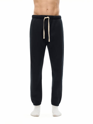 Black sweatpants with a drawstring on a white background