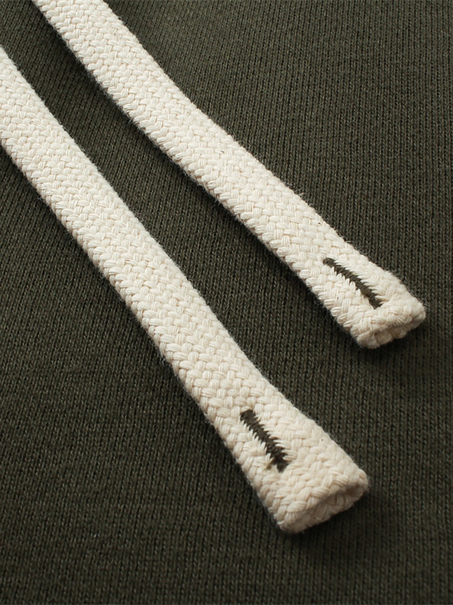 Close-up of white shoelaces with a brand logo on a dark background