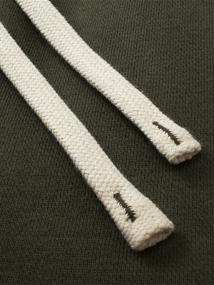 Close-up of white shoelaces with a brand logo on a dark background
