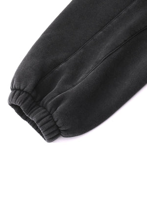 Close-up of dark gray sweatpants on a white background