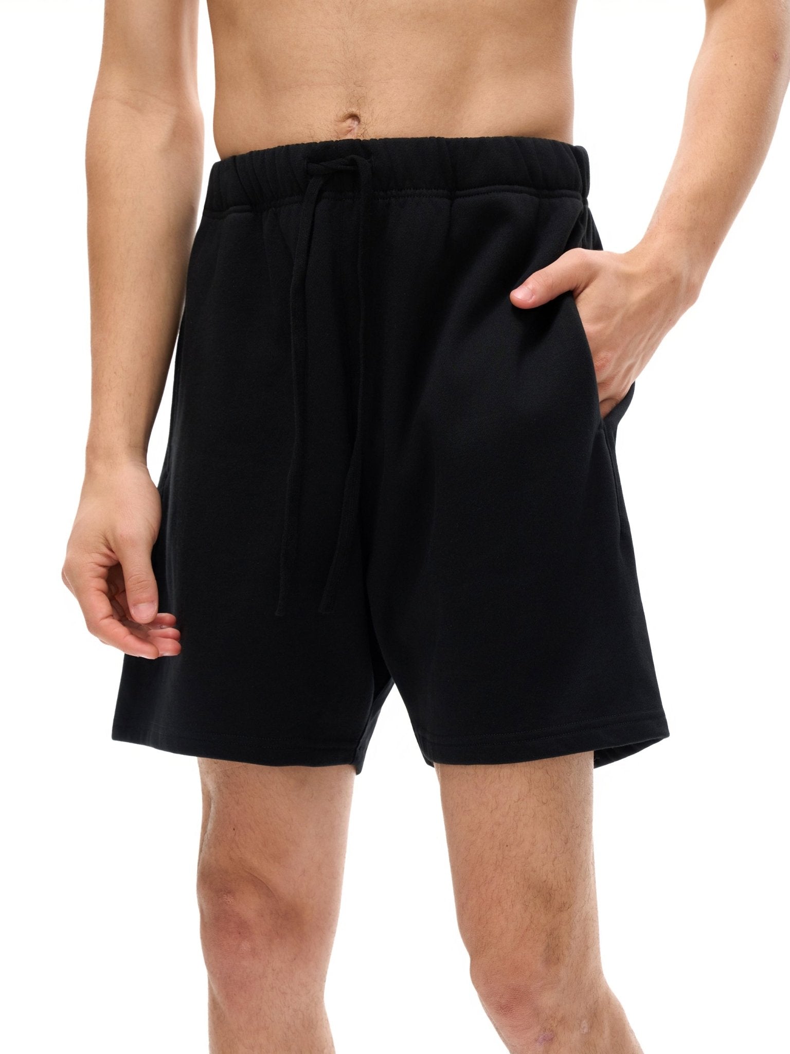 Black shorts worn by a person on a white background