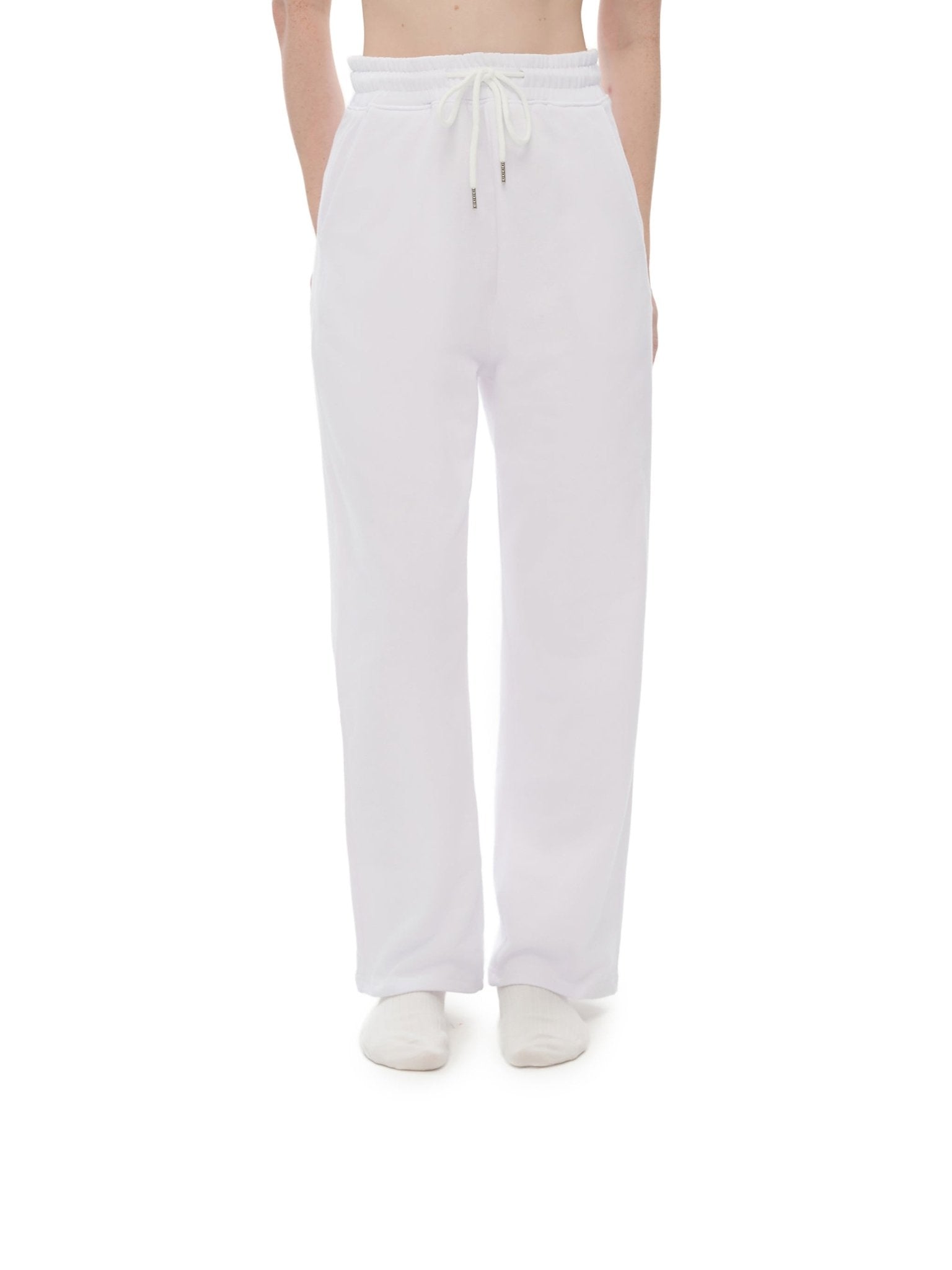 White pants worn by a person on a white background