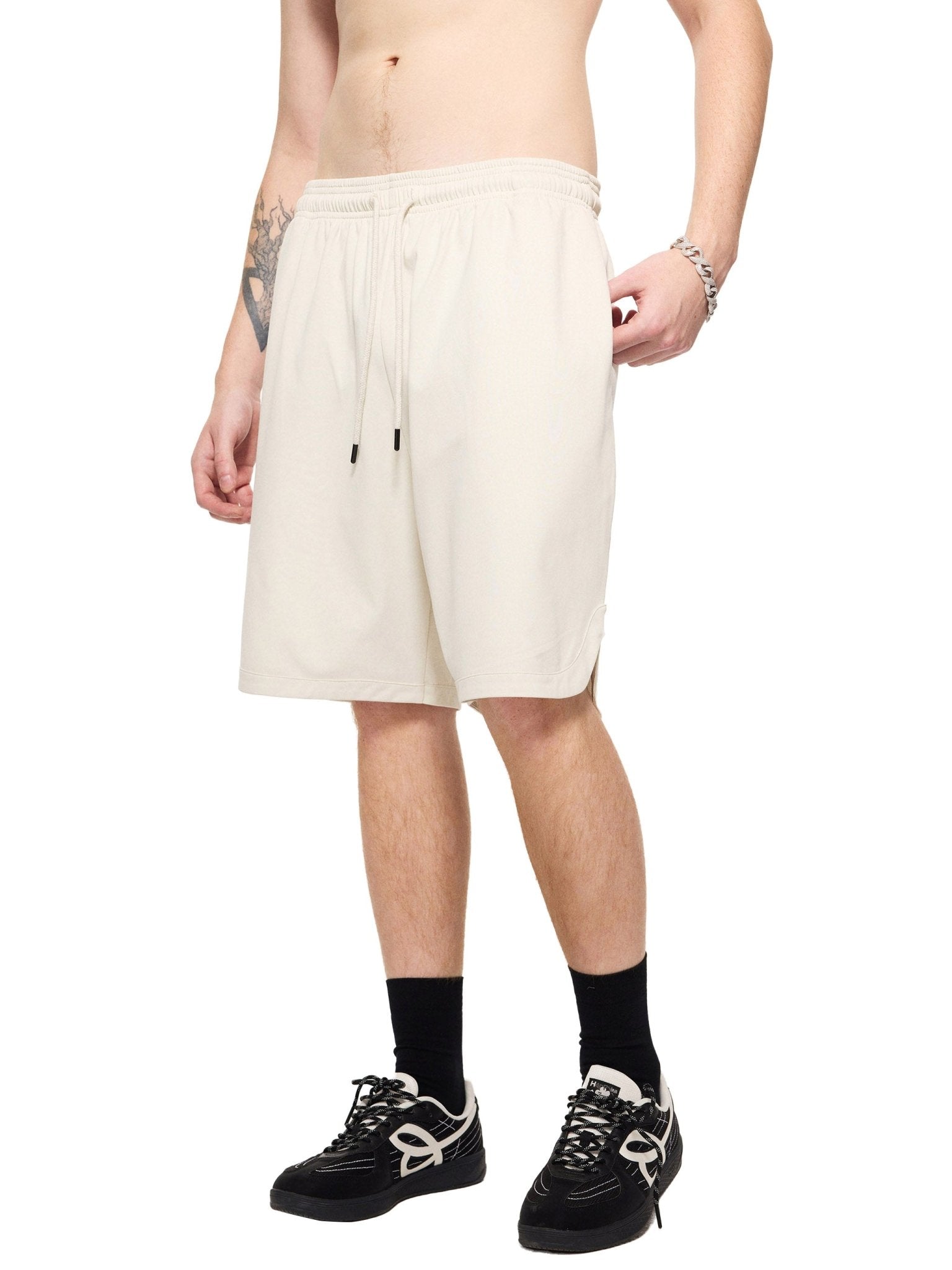 Person wearing white shorts on a white background