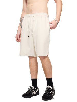 Person wearing white shorts on a white background