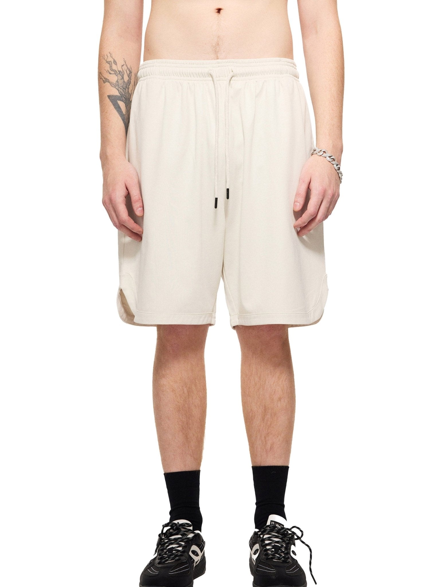 Person wearing white shorts on a white background
