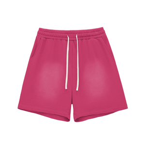 Pink shorts with a white drawstring on a white background