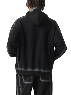 Person wearing a black hoodie and pants on a white background