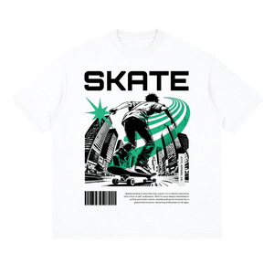 A white short-sleeve crewneck t-shirt featuring a bold graphic print on the front. The design displays the word 'SKATE' in large black capital letters above an illustration of a skateboarder in black and white, accented with a vibrant green starburst and green curved lines.