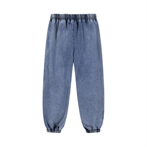 Blue denim jogger pants on a white background