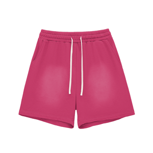 Pink shorts with a white drawstring on a white background
