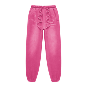 Pink velvet jogger pants with ruffled drawstring on a white background