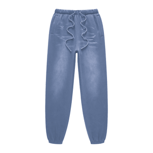 Blue sweatpants with ruffled waistband on a white background
