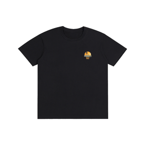 A black short-sleeve crewneck t-shirt with a small circular graphic on the left chest, displayed flat against a solid white background.