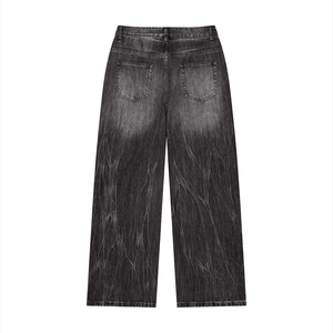 Black distressed jeans on a white background